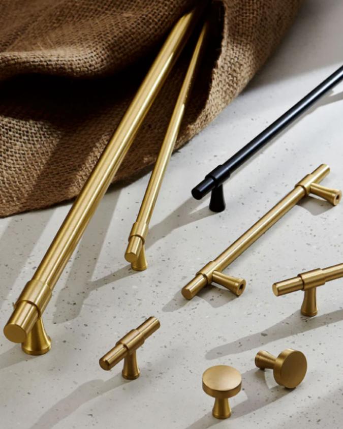 Multiple handles and knobs. gold brass modern handles and black matte handle.