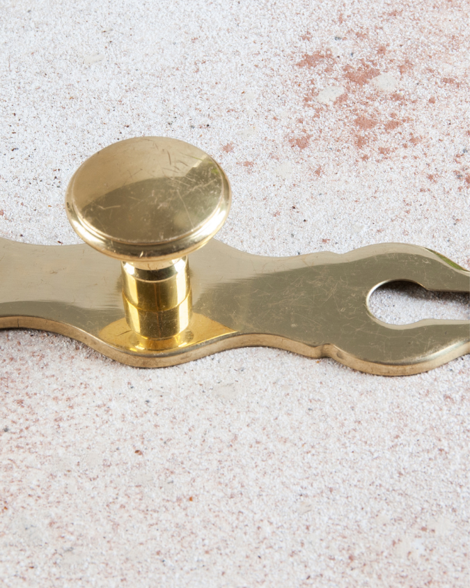 antique gold knob with whimsical gold plate.